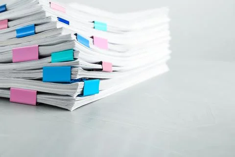 Stack of documents with binder clips on light table Foto stock