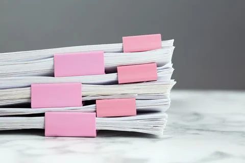Stack of documents with binder clips on marble table, closeup 库存照片
