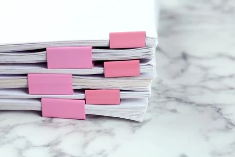 Stack of documents with binder clips on marble table, closeup Foto stock