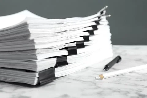 Stack of documents with binder clips on marble table, closeup 스톡 사진