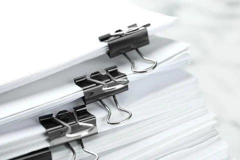 Stack of documents with binder clips on marble table, closeup Stockfoto's