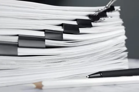Stack of documents with binder clips on marble table, closeup Foto stock