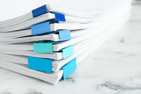 Stack of documents with binder clips on marble table, closeup Stock Photos
