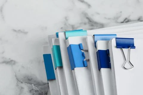 Stack of documents with binder clips on marble table, above view 스톡 사진