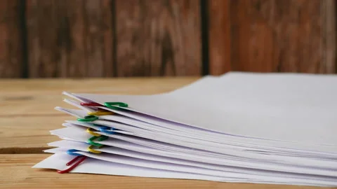 Stack of documents with binder clips wooden table, stop motion animation, clo 库存影片 149046263