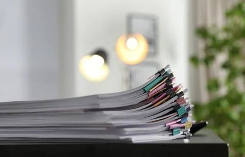 Stack of documents with paper clips on office table. Space for text Foto stock