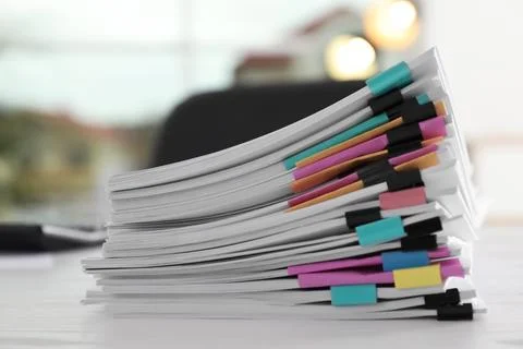 Stack of documents with paper clips on office table Foto stock