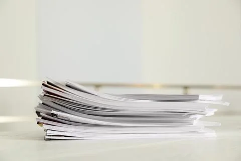 Stack of documents with paper clips on office table. Space for text 库存照片