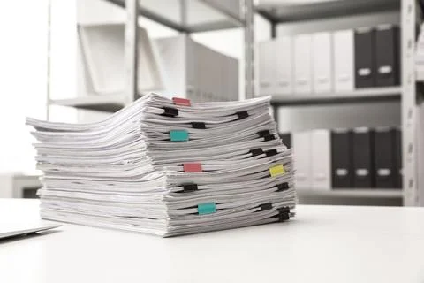 Stack of documents with paper clips on office desk. Space for text Stock Photos