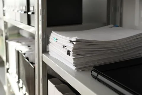 Stack of documents with paper clips on shelf in office 写真素材