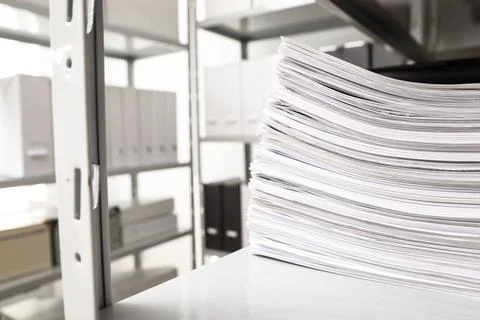 Stack of documents on shelf in office. Space for text 库存照片