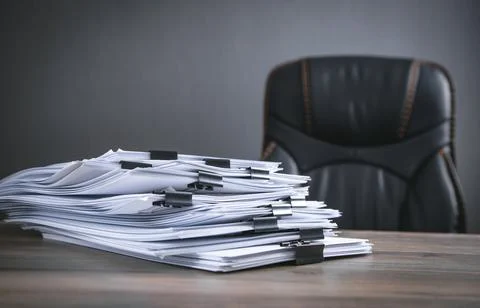 Stack of documents on table in office. Stock Photos
