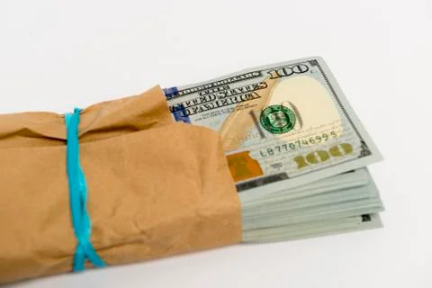 Stack of dollar banknotes and brown envelope Stock Photos