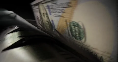 Stack of dollar banknotes put into bill counter for calculation Stock Footage 274086226