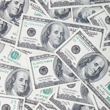 A stack of dollar bills as a background. Stock Photos