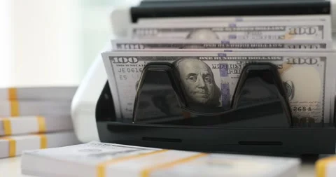 Stack of dollar bills being processed by money counting machine Stock Footage 314101372