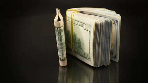Stack of dollar bills collected in an elastic band and a stationery clip Stock Footage 256935108