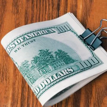 Stack of dollars bonded office clip lying on the wooden boards. Foto stock