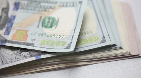 A stack of dollars is falling on table Stock Footage 43564216