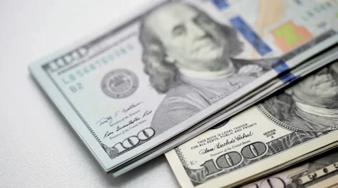 A stack of dollars is falling on table Stock Footage 43564288