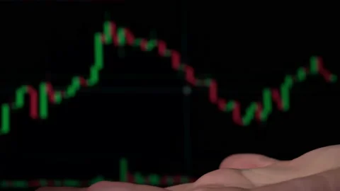 Stack of Dollars Falls Into a Hand Against the Background of a Stock Market Stock Footage 201340214