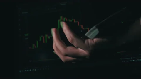 Stack of Dollars Falls Into a Hand Against the Background of a Stock Market Stock Footage 201340233