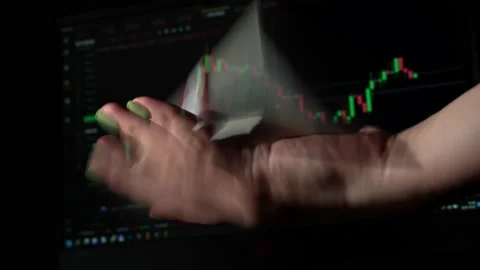 Stack of Dollars Falls Into a Hand Against the Background of a Stock Market Stock Footage 201340256