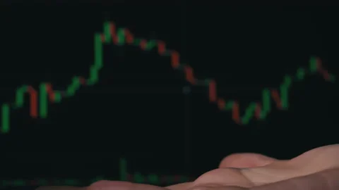 Stack of Dollars Falls Into a Hand Against the Background of a Stock Market Stock Footage 201351280