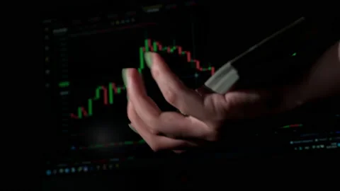 Stack of Dollars Falls Into a Hand Against the Background of a Stock Market Stock Footage 201351289