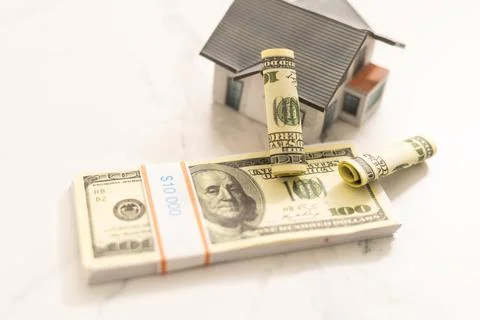 Stack of dollars as a Foundation to a house. Stock Photos