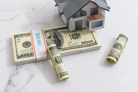 Stack of dollars as a Foundation to a house. Stock Photos