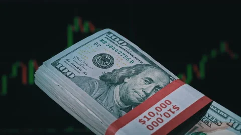 Stack of Dollars in a Hand on the Background of a Stock Market Chart Stock Footage 201340074