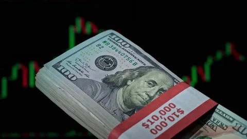Stack of Dollars in a Hand on the Background of a Stock Market Chart Stock Footage 201351265