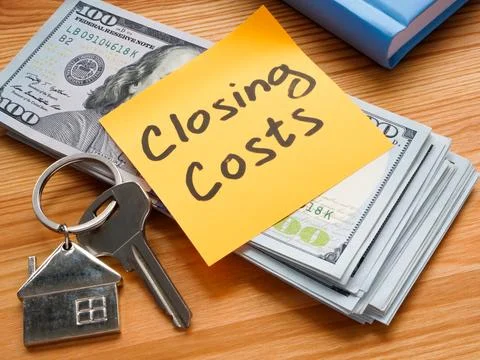 Stack of dollars, keys and inscription closing costs. Stock Photos