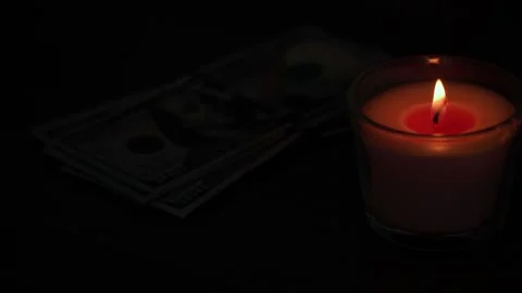 A stack of dollars next to a burning candle. Stock Footage 239362459