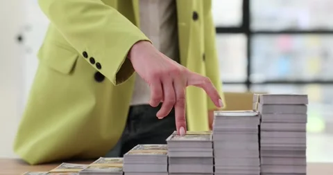 Stack of dollars on stairs in office and hands Stock Footage 260814432
