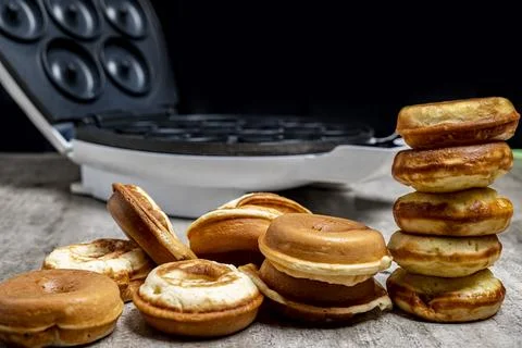 A stack of donuts and a waffle iron Stock Photos