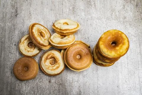 A stack of donuts with a variety of flavors and sizes Stock Photos