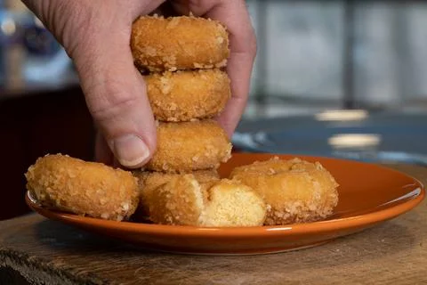 Stack of doughnuts with hand taking 3 Stock Photos