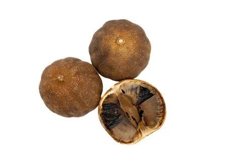 Stack of dried black lemons on white background, loomi Stock Photos