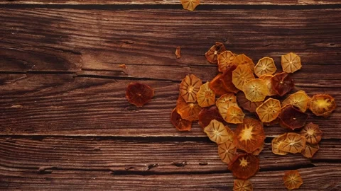 A stack of dried oranges on a brown hardwood table Stock Footage 268610619
