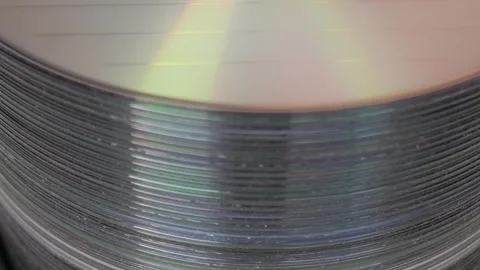 Stack of DVDs with rainbow reflection, close-up Stock Footage 315125472