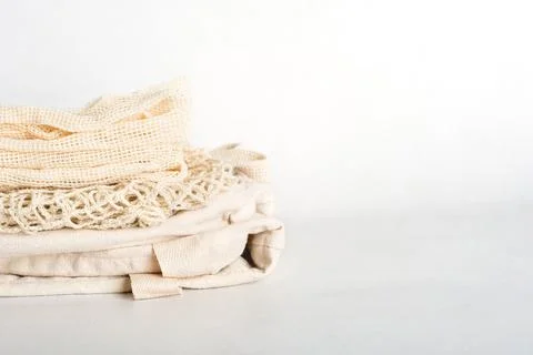 Stack of eco friendly bags on a grey background. String and canvas bags made  Stock Photos