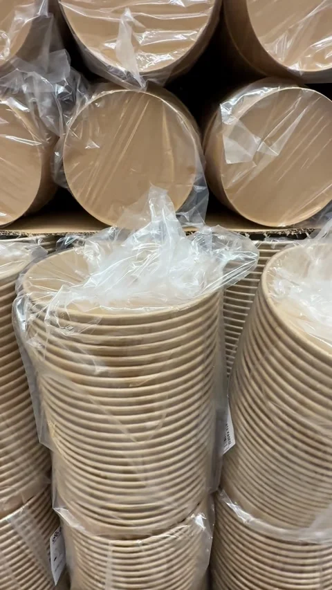 Stack of eco-friendly paper plates wrapped in plastic packaging on display .. Stock Footage 331385523