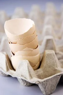 A stack of egg shells on the egg tray Stock Photos