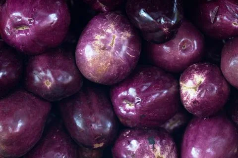 Stack of eggplants on a market stall Stock Photos