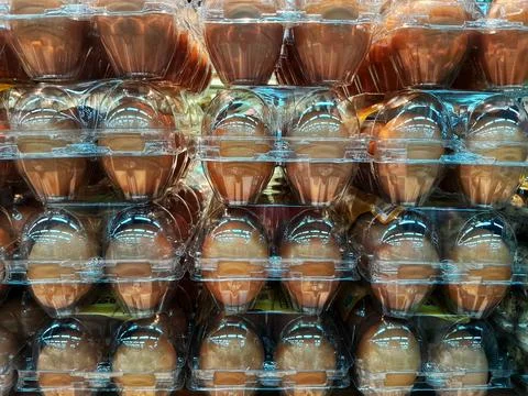 Stack of eggs on PET plastic transparent for sale in supermarket. Stock Photos