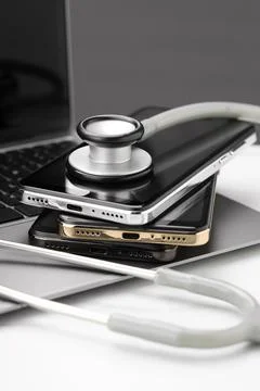 Stack of electronic devices and stethoscope on white table 스톡 사진