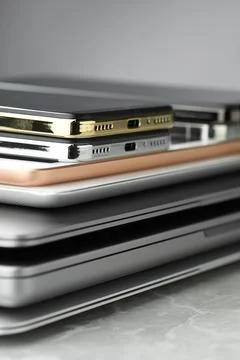 Stack of electronic devices on grey stone table, closeup Stock Photos