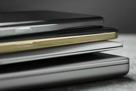 Stack of electronic devices on grey table, closeup Foto stock